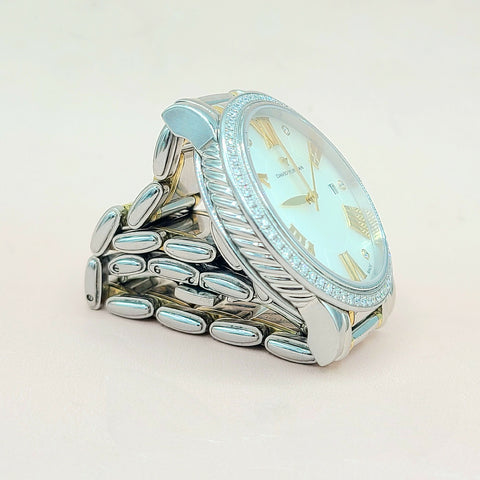 Silver ring with a clock face design on a light background