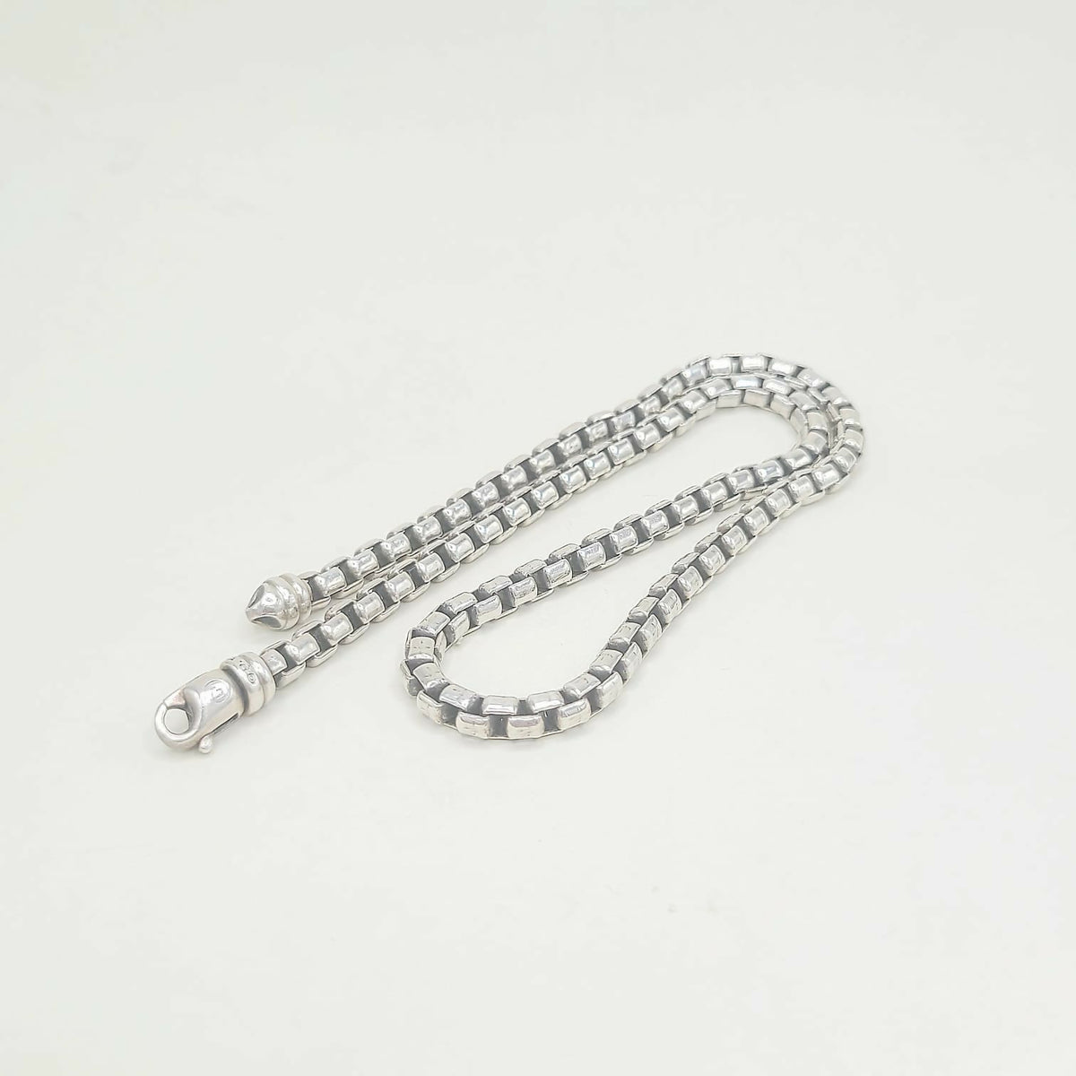 Silver chain necklace on a white background