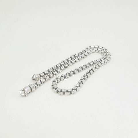 Silver chain necklace on a white background