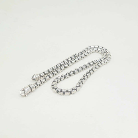 Silver chain necklace on a white background
