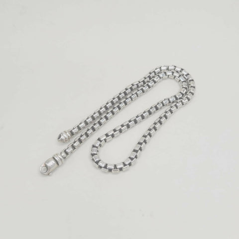 Silver chain on a light gray background