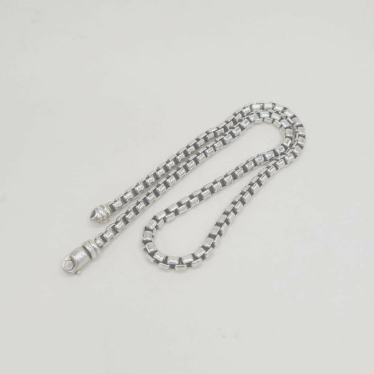 Silver chain on a light gray background