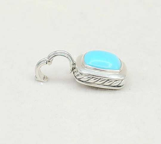 Silver earring with a turquoise stone on a white background