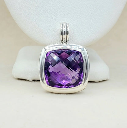 Purple gemstone pendant with silver frame on a white background