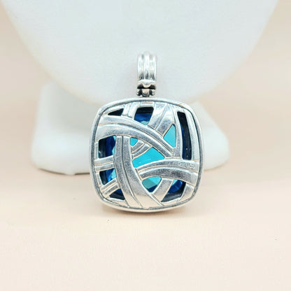 Silver pendant with blue interior on a white background