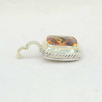 Jewelry charm with amber stone on a white background