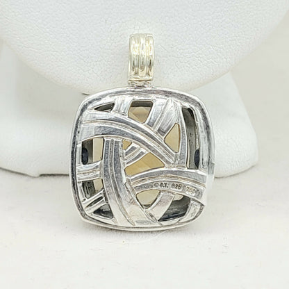 Silver pendant with geometric design on a white background