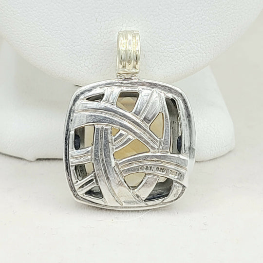 Silver pendant with geometric design on a white background