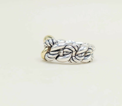 Silver braided ring on a light beige background