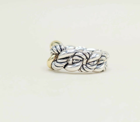 Silver braided ring on a light beige background