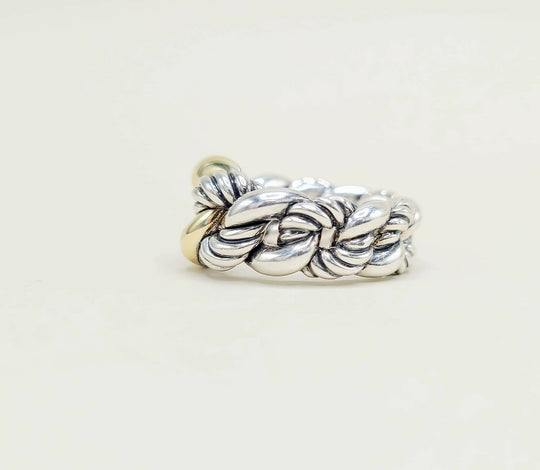 Silver braided ring on a light beige background