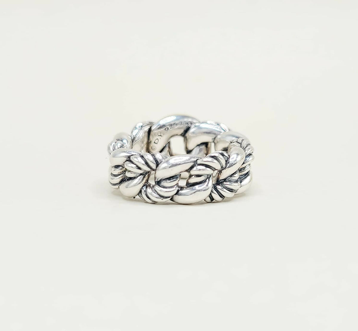 Silver braided ring on a white background