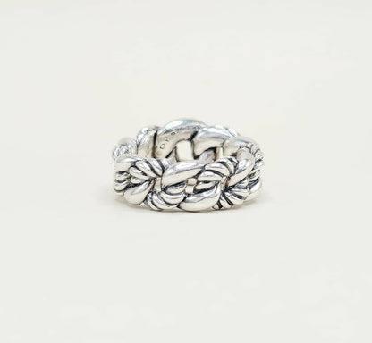 Silver braided ring on a white background