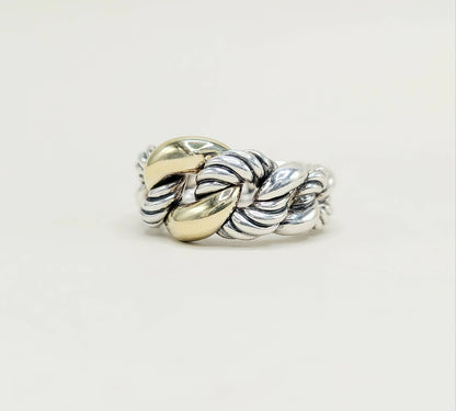 Silver and gold braided ring on a light gray background