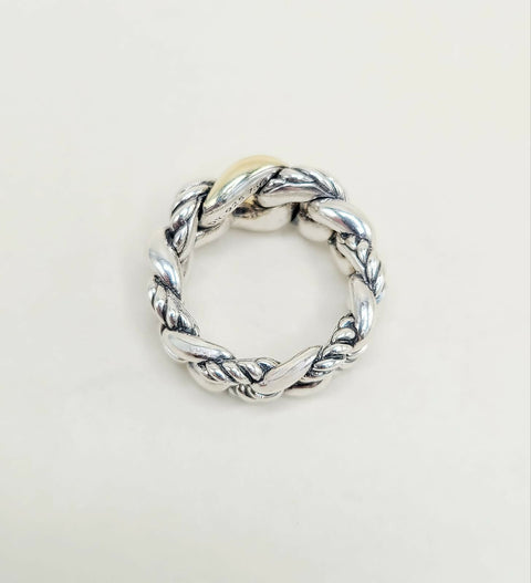 Silver twisted ring on a light gray background