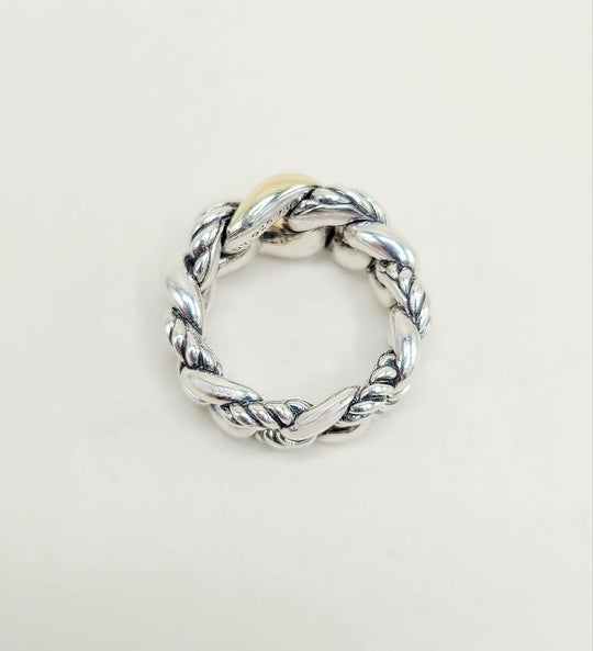 Silver twisted ring on a light gray background