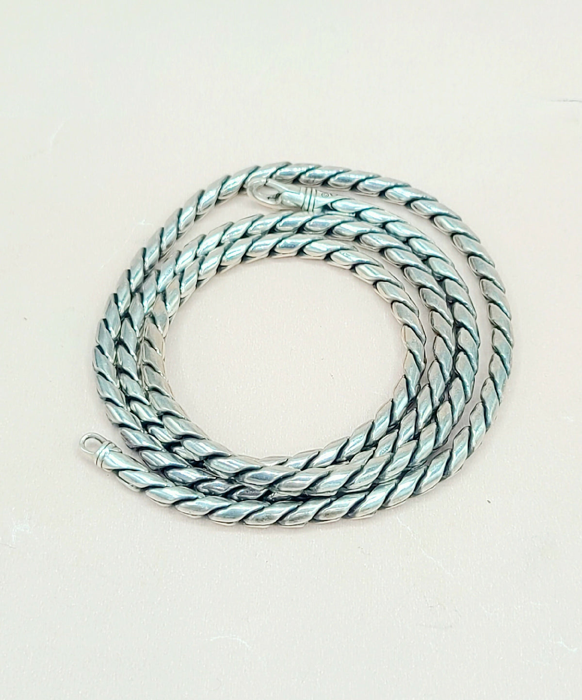 Necklace with braided design on a light background