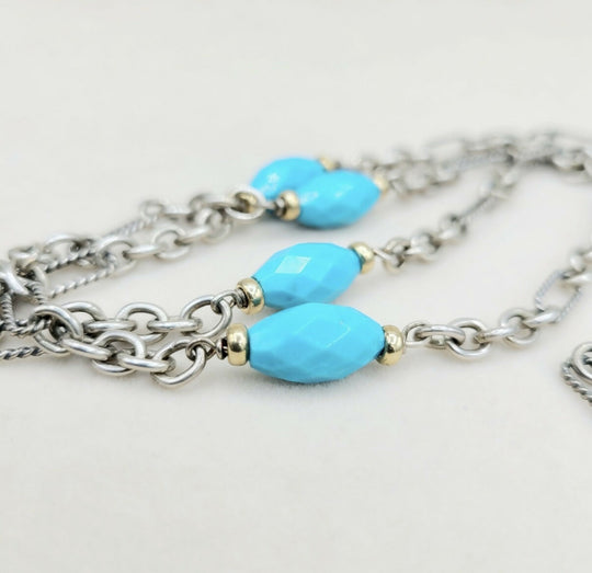 Necklace with turquoise beads and silver chain on a white background