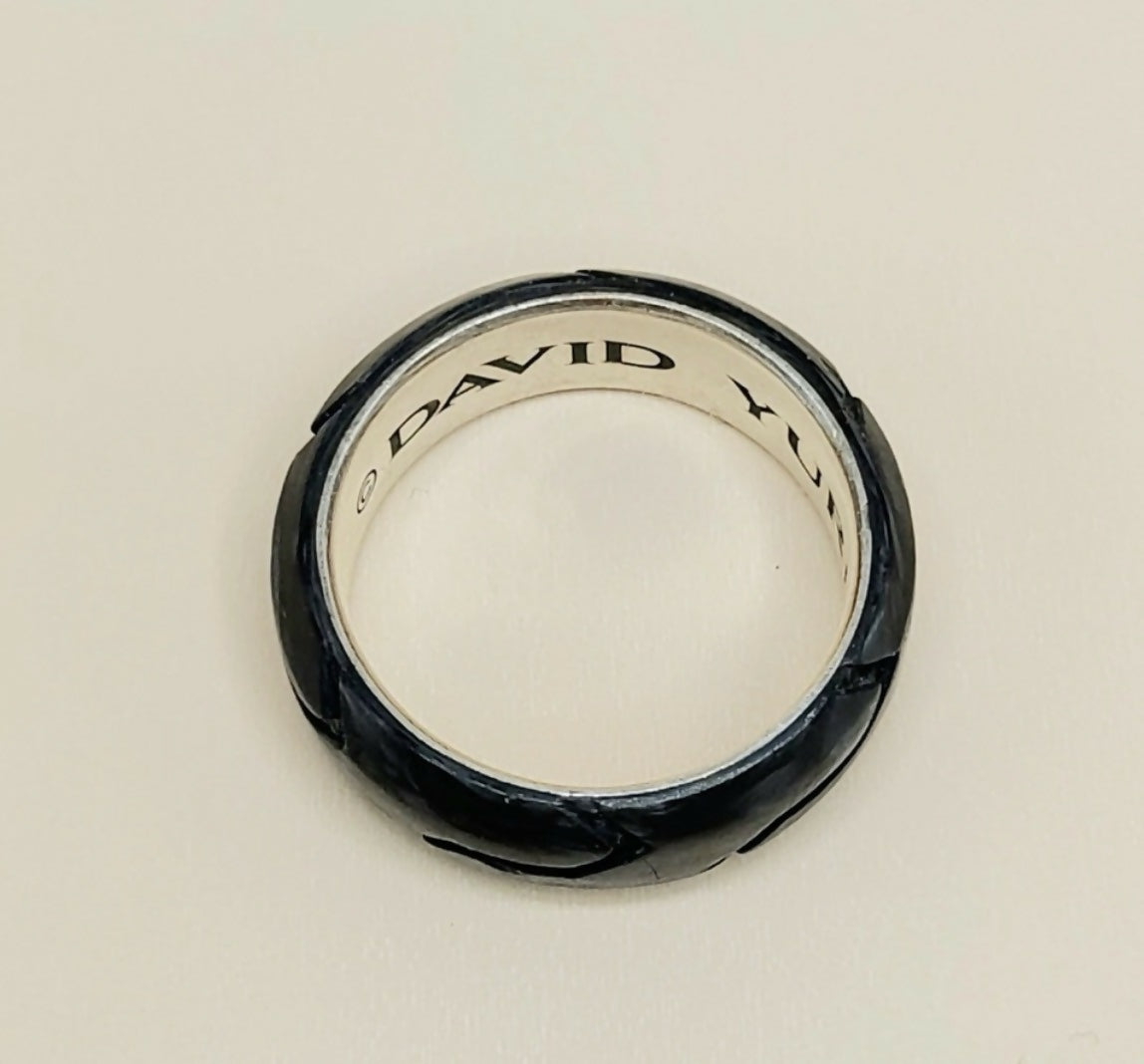 A David Yurman ring with a textured black exterior and a polished silver interior, shown on a plain light background.