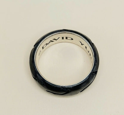 A David Yurman ring with a textured black exterior and a polished silver interior, shown on a plain light background.