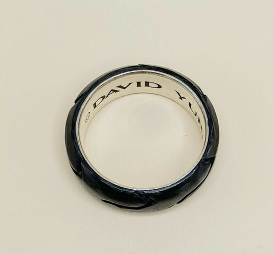 A David Yurman ring with a textured black exterior and a polished silver interior, shown on a plain light background.