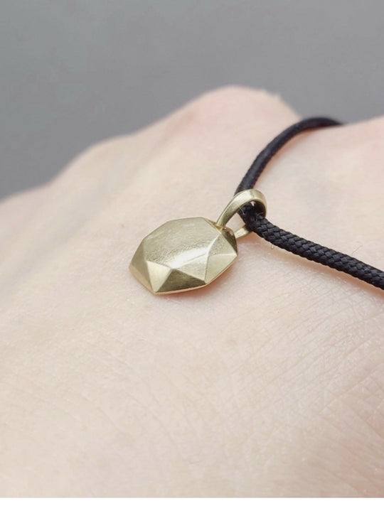 displaying David Yurman Fortune Amulet Pendant 18K Gold on Adjustable Black Cord 12mm