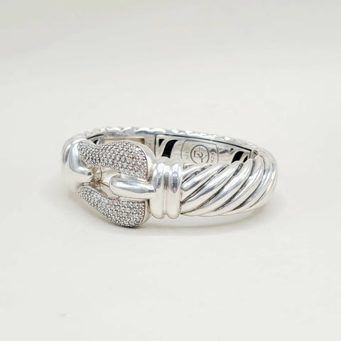 Silver ring with intricate design on a white background