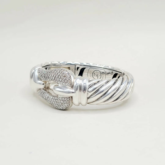 Silver ring with intricate design on a white background