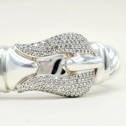 Silver bracelet with diamond accents on a white background