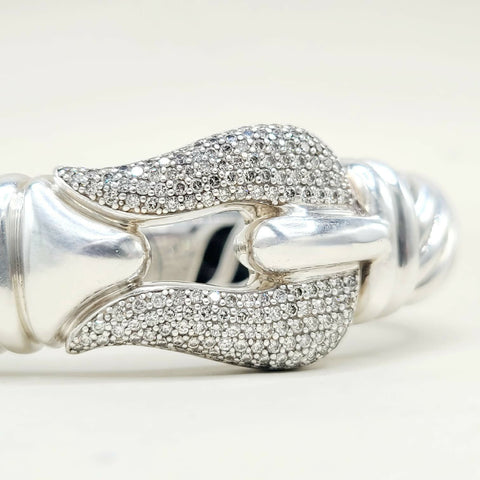 Silver bracelet with diamond accents on a white background