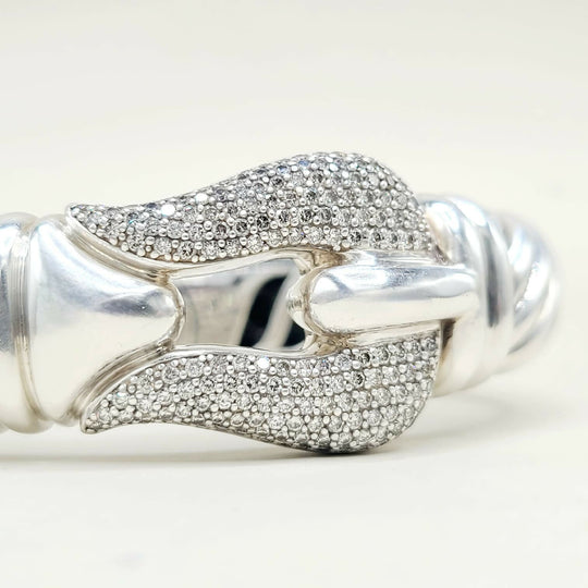 Silver bracelet with diamond accents on a white background
