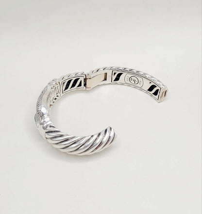 Silver bracelet on a light gray background