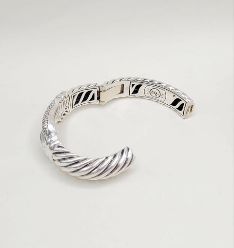 Silver bracelet on a light gray background