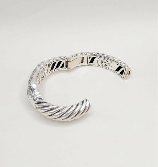 Silver bracelet on a light gray background