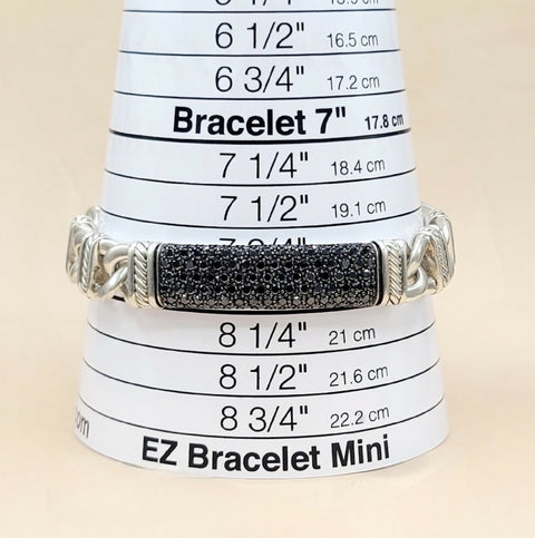 A silver-toned EZ Bracelet Mini displayed on a white cone size chart labeled 'Bracelet 7"' and 'EZ Bracelet Mini,' with a black textured rectangular center panel.