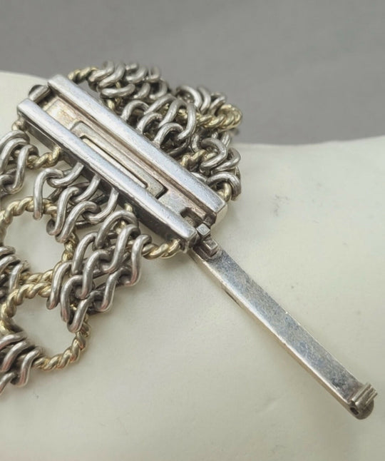 Silver chain necklace with a bar clasp on a white background