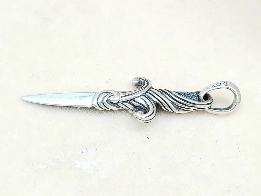 Silver letter opener with decorative handle on a white background