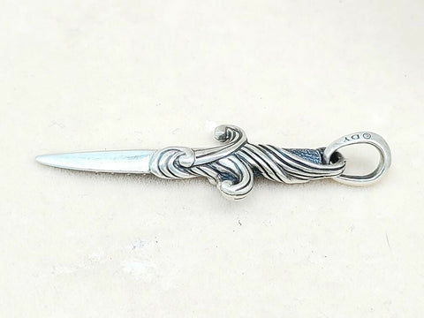 Silver letter opener with decorative handle on a white background