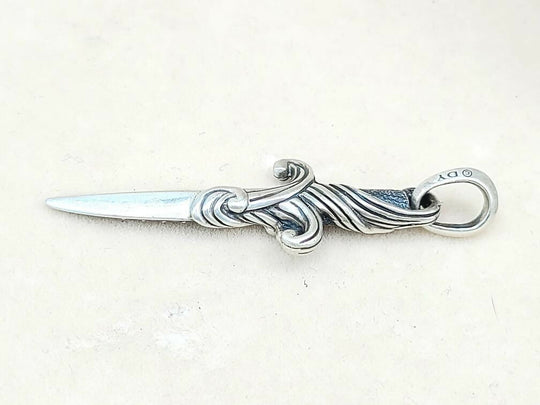 Silver letter opener with decorative handle on a white background