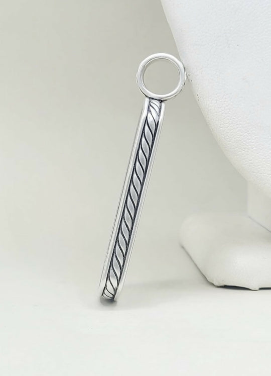A sterling silver bar pendant with a twisted cable design and a circular loop at the top, displayed on a white jewelry bust against a light gray background.
