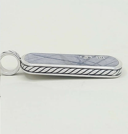 A silver-toned Gucci keychain or card holder featuring a blue-gray marble inlay with a subtle diamond pattern and a black twisted rope border, with the interlocking GG logo and a small square Gucci emblem on the top.