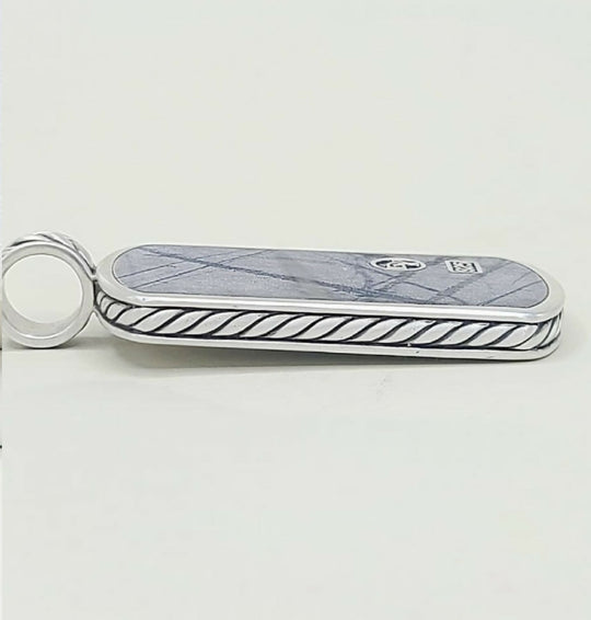 A silver-toned Gucci keychain or card holder featuring a blue-gray marble inlay with a subtle diamond pattern and a black twisted rope border, with the interlocking GG logo and a small square Gucci emblem on the top.